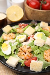 Photo of Delicious Caesar salad with shrimps on table, closeup