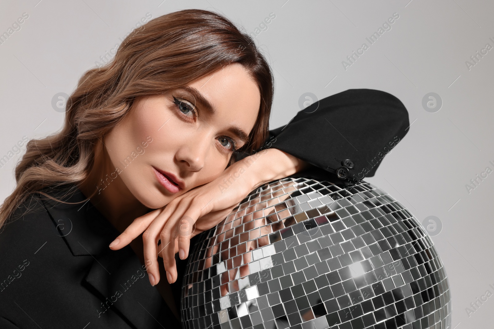 Photo of Beautiful woman with disco ball on white background