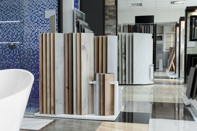 Photo of Assortment of tiles in store. Many different samples indoors