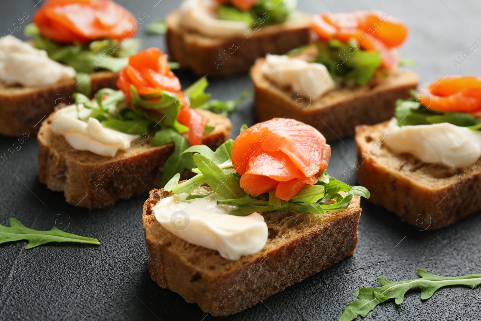 Photo of Tasty sandwiches with fresh sliced salmon fillet on table