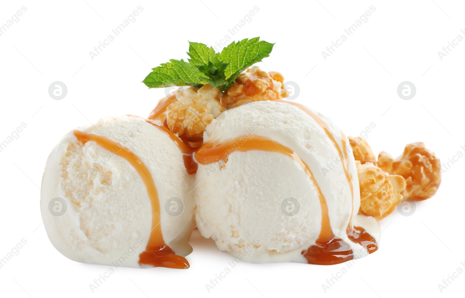 Photo of Scoops of delicious ice cream with caramel sauce, mint and popcorn on white background