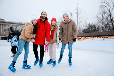 Group of friends at outdoor ice skating rink