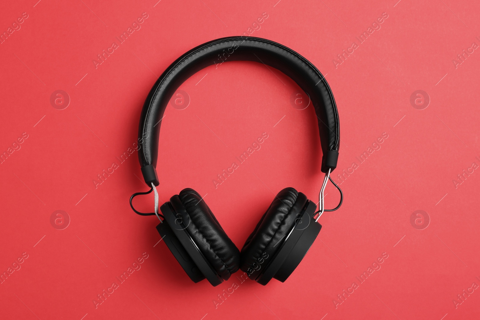 Photo of Stylish headphones on color background, top view