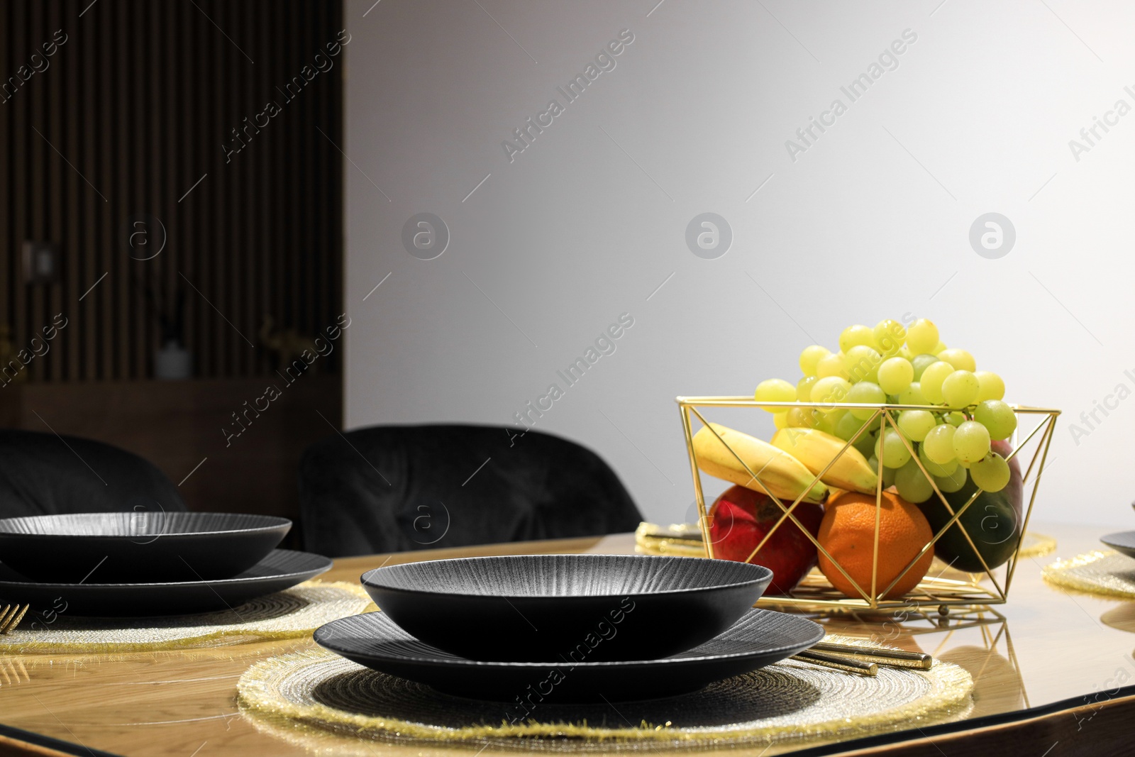 Photo of Table set for dinner near white wall