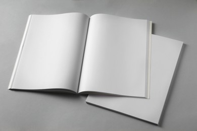 Photo of Paper sheets and open blank brochure on light grey background