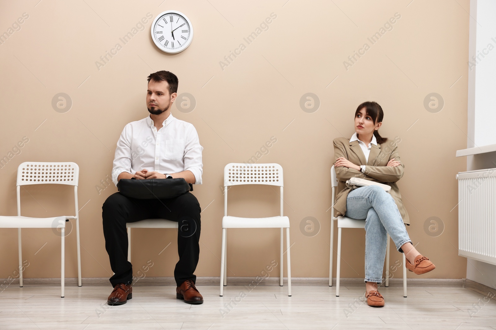 Photo of Man and woman waiting for job interview indoors