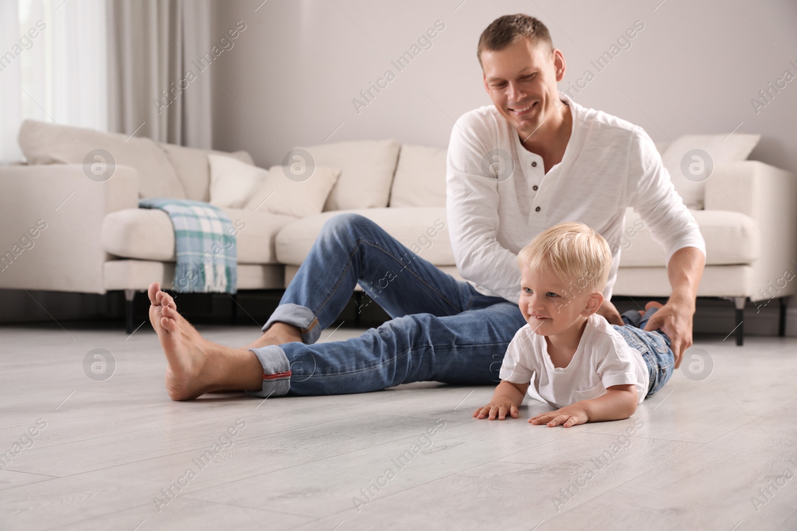 Photo of Father with his cute little son in living room