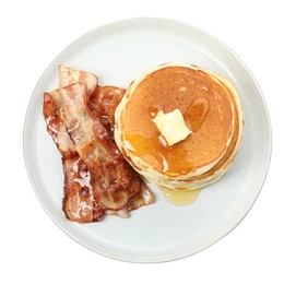 Delicious pancakes with maple syrup, butter and fried bacon on white background, top view