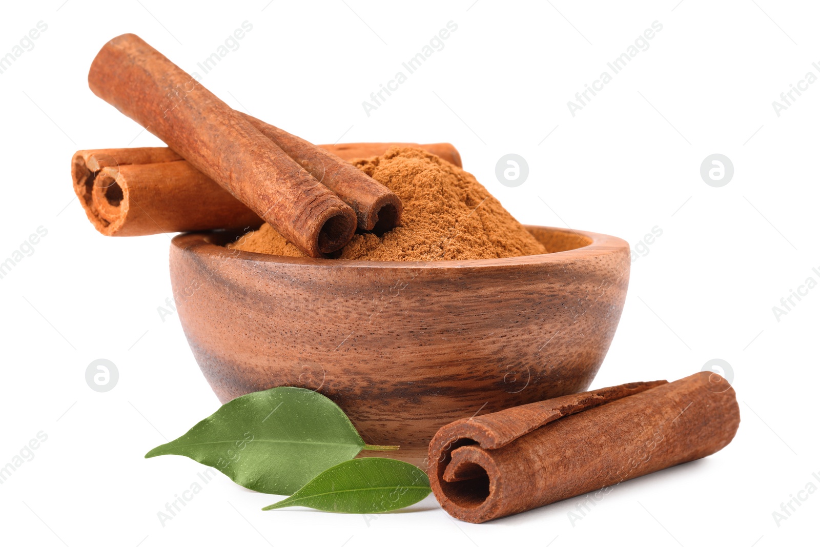 Photo of Dry aromatic cinnamon sticks, powder and green leaves isolated on white