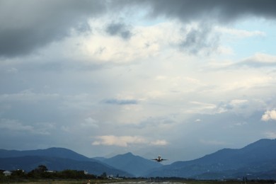 Photo of Modern white airplane and takeoff runway in evening