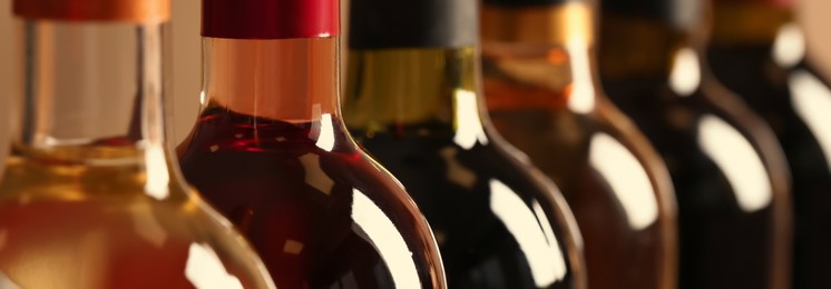 Image of Bottles of different wines, closeup. Banner design