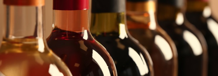 Bottles of different wines, closeup. Banner design