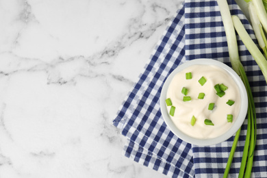 Photo of Fresh sour cream with onion on white marble table, flat lay. Space for text