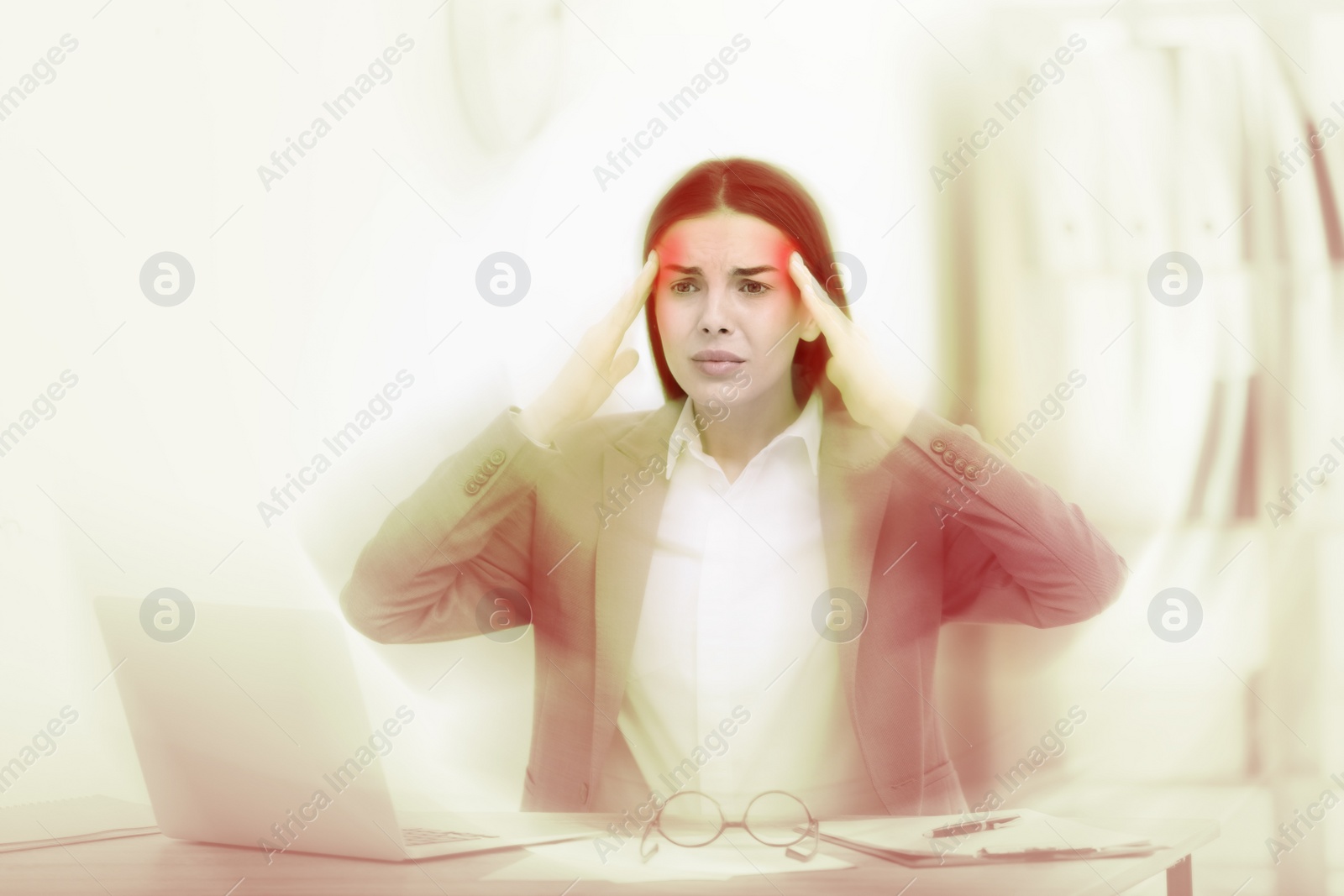 Image of Woman suffering from migraine at workplace in office