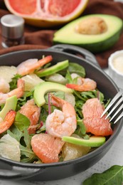 Delicious pomelo salad with shrimps served on white wooden table, closeup