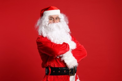Photo of Merry Christmas. Santa Claus posing on red background