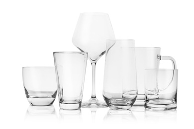 Photo of Set of empty glasses for different drinks on white background