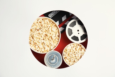 Composition with popcorn and cinema reel on color background, top view