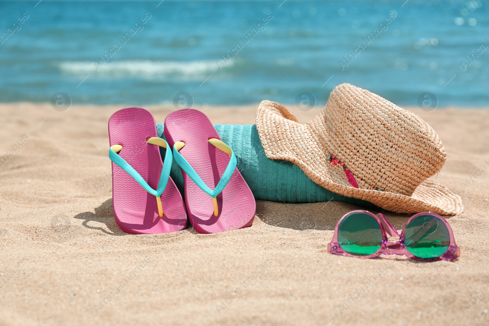 Photo of Set of different beach objects on sand near sea