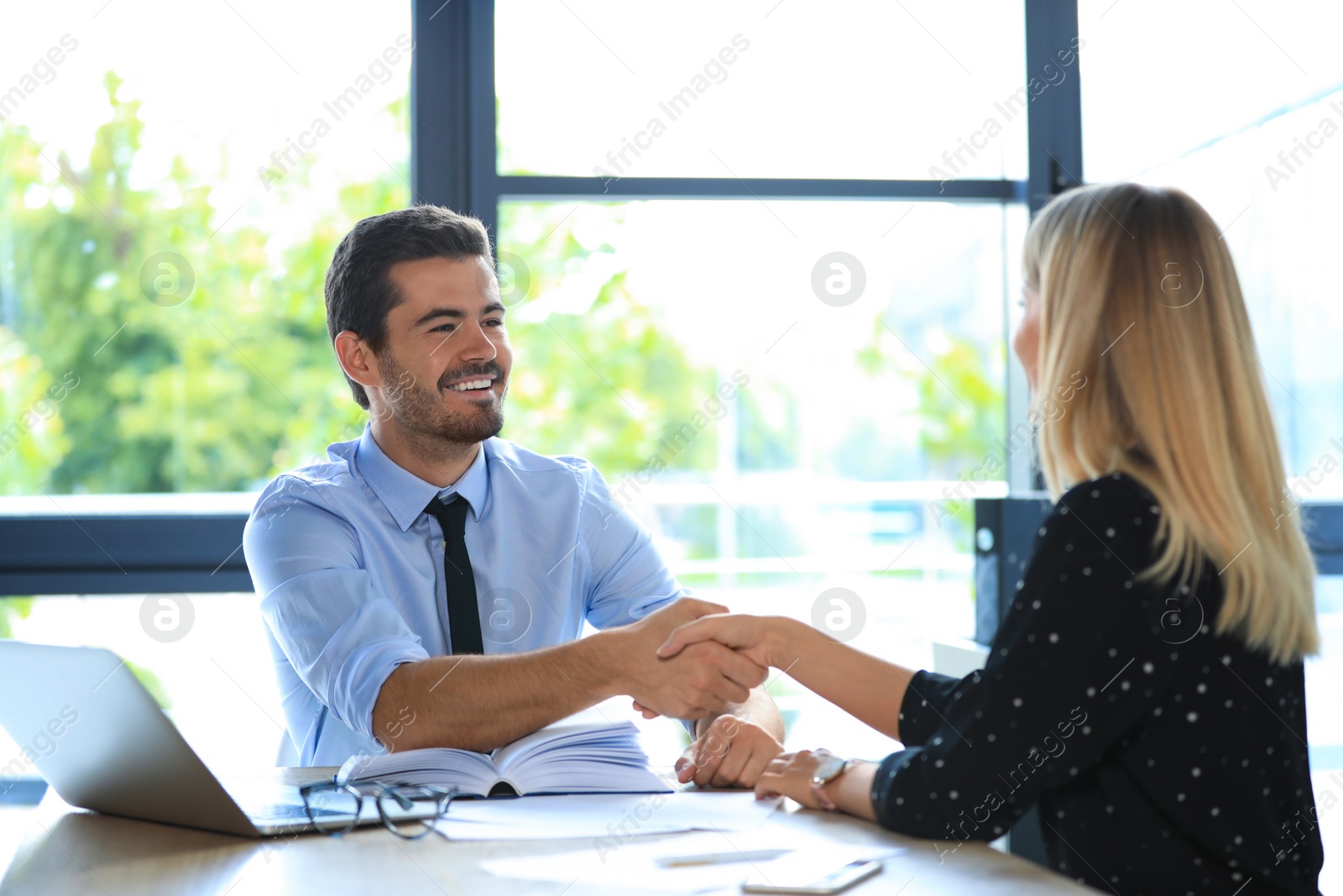 Photo of Male business trainer coaching young woman in office