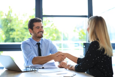 Male business trainer coaching young woman in office