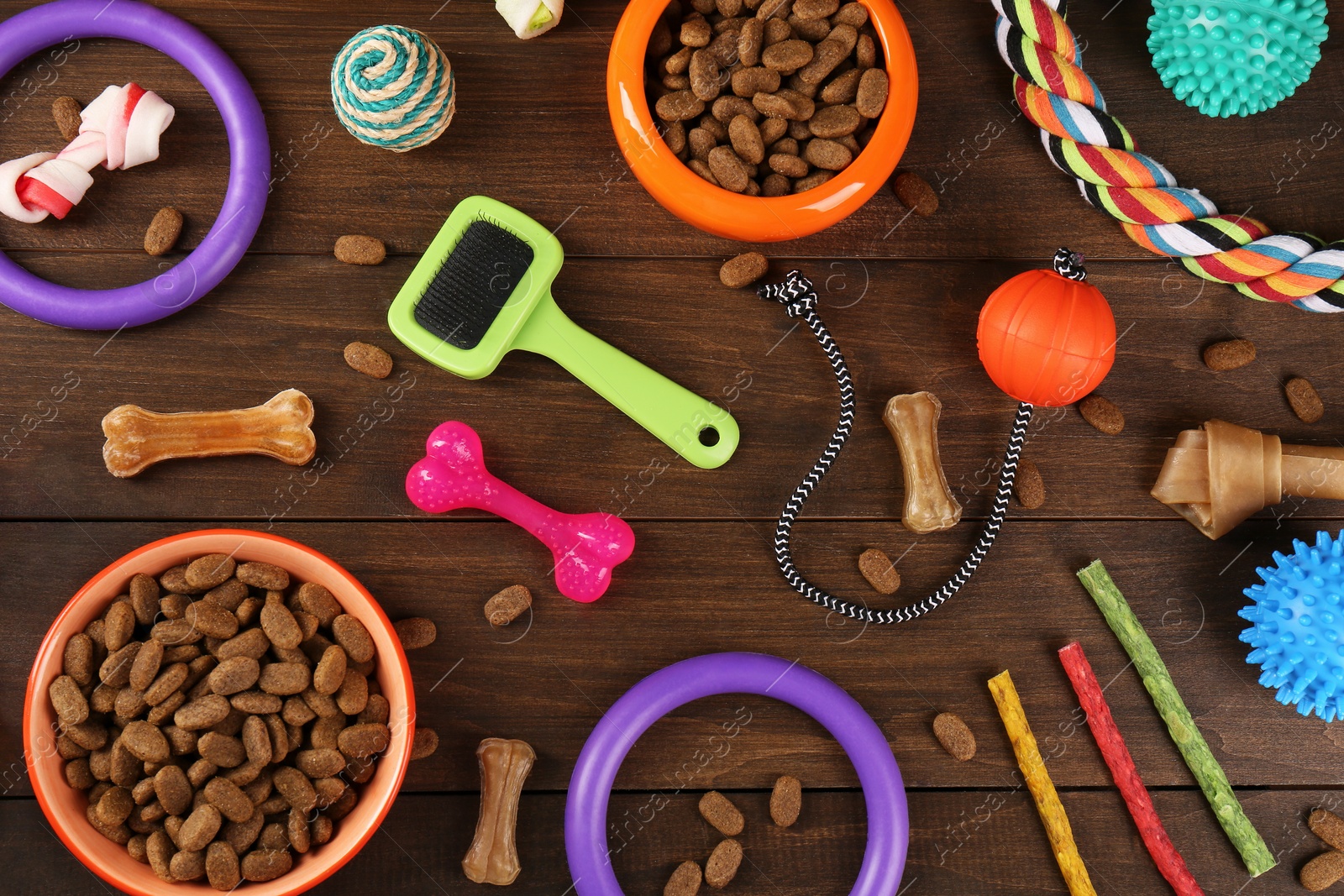 Photo of Flat lay composition with different pet goods on wooden background. Shop assortment