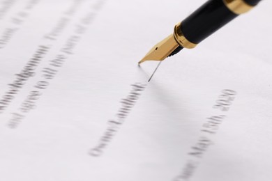 Photo of Writing on document with fountain pen, closeup. Notary contract