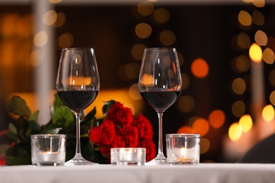 Glasses of wine for romantic dinner on table in restaurant