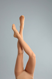 Photo of Woman wearing tights on light grey background, closeup of legs