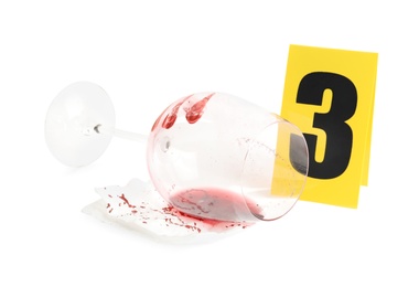 Photo of Wine glass with fingerprints, napkin and crime scene marker with number three isolated on white