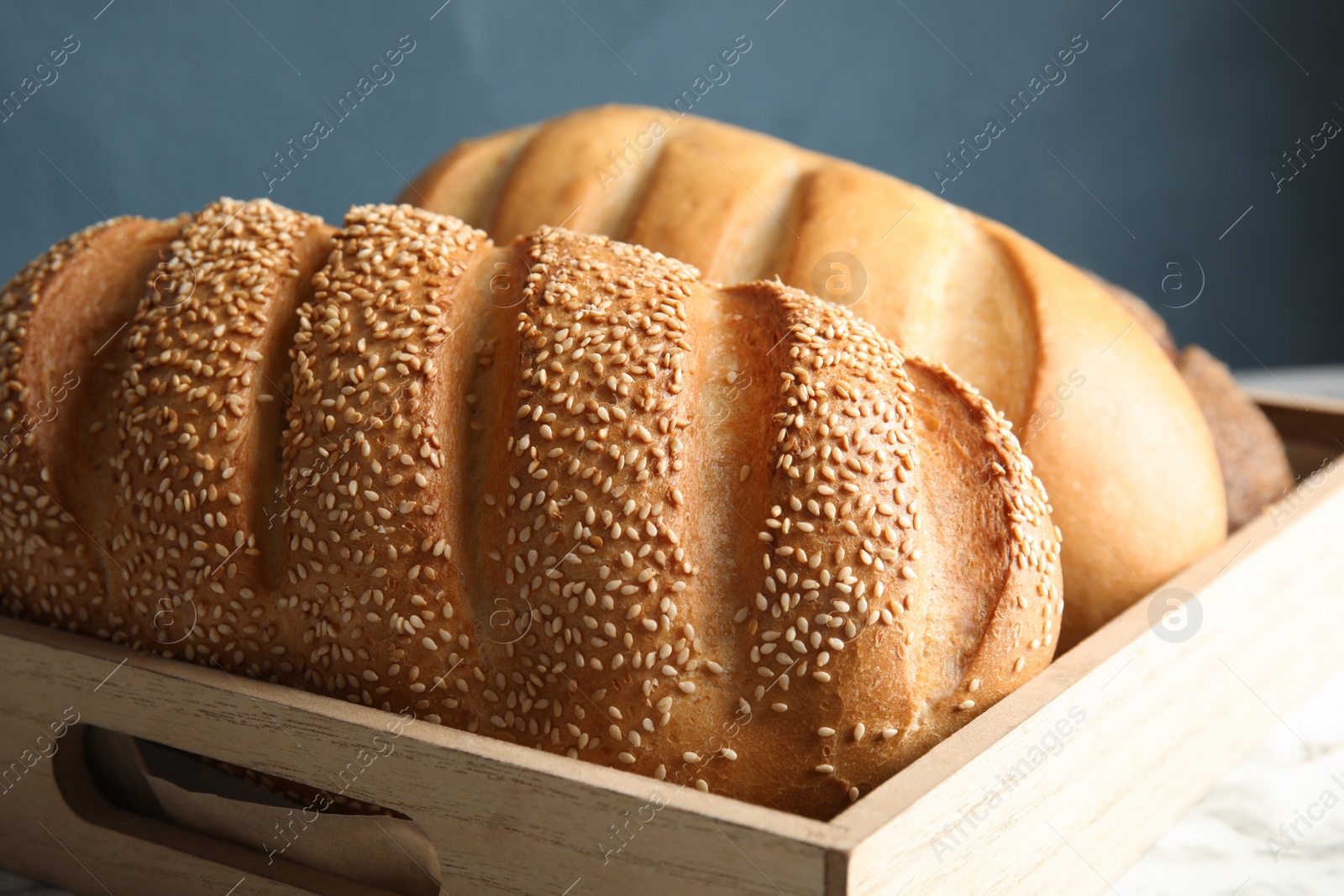 Photo of Tray with fresh bread on table, closeup