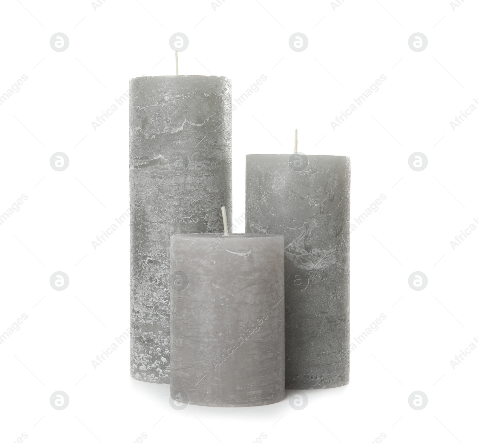 Photo of Three color wax candles on white background