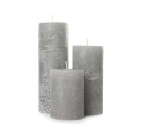 Three color wax candles on white background