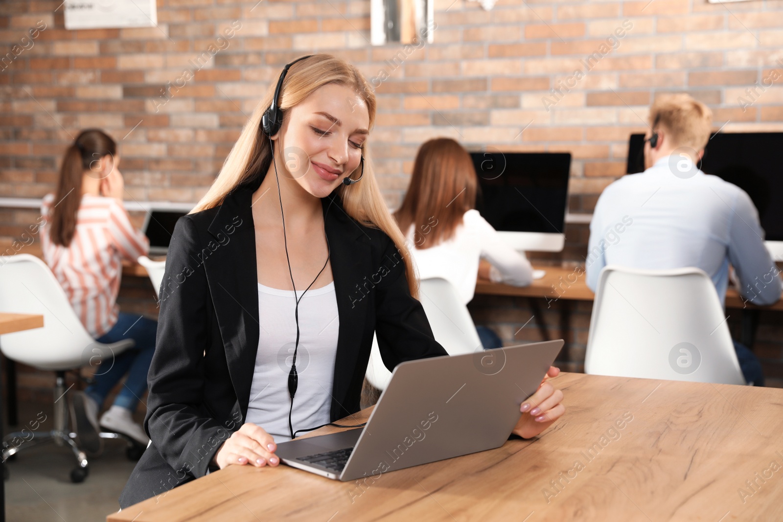 Photo of Technical support operator with headset in modern office