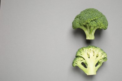 Photo of Fresh tasty broccoli on grey background, flat lay. Space for text