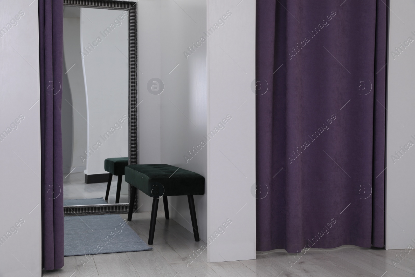 Photo of Empty dressing room in fashion store. Stylish interior