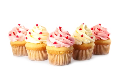 Photo of Tasty cupcakes with heart shaped sprinkles on white background. Valentine's Day celebration