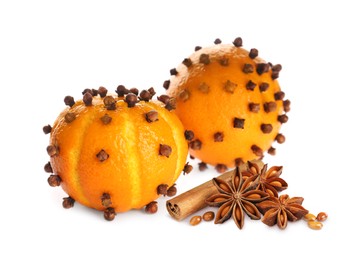 Fresh ripe pomander balls, cloves, anise and cinnamon on white background