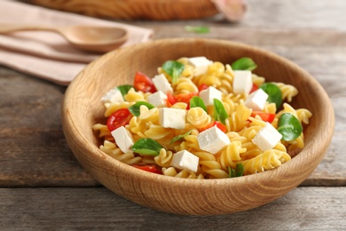 Plate with delicious pasta primavera on table