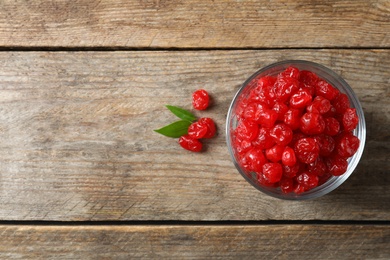 Photo of Bowl of sweet cherries on wooden background, top view with space for text. Dried fruit as healthy snack