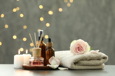 Composition with different spa products and rose flower on light table