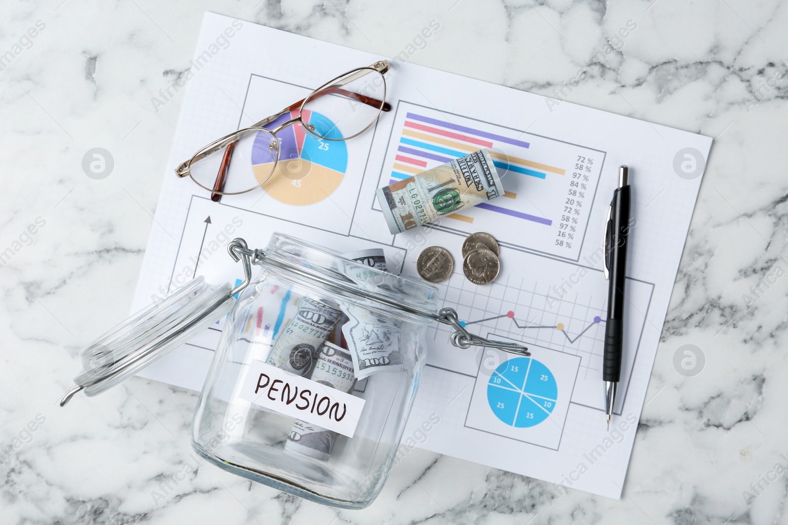 Photo of Glass jar with word Pension, money, chart and glasses on white marble table, flat lay