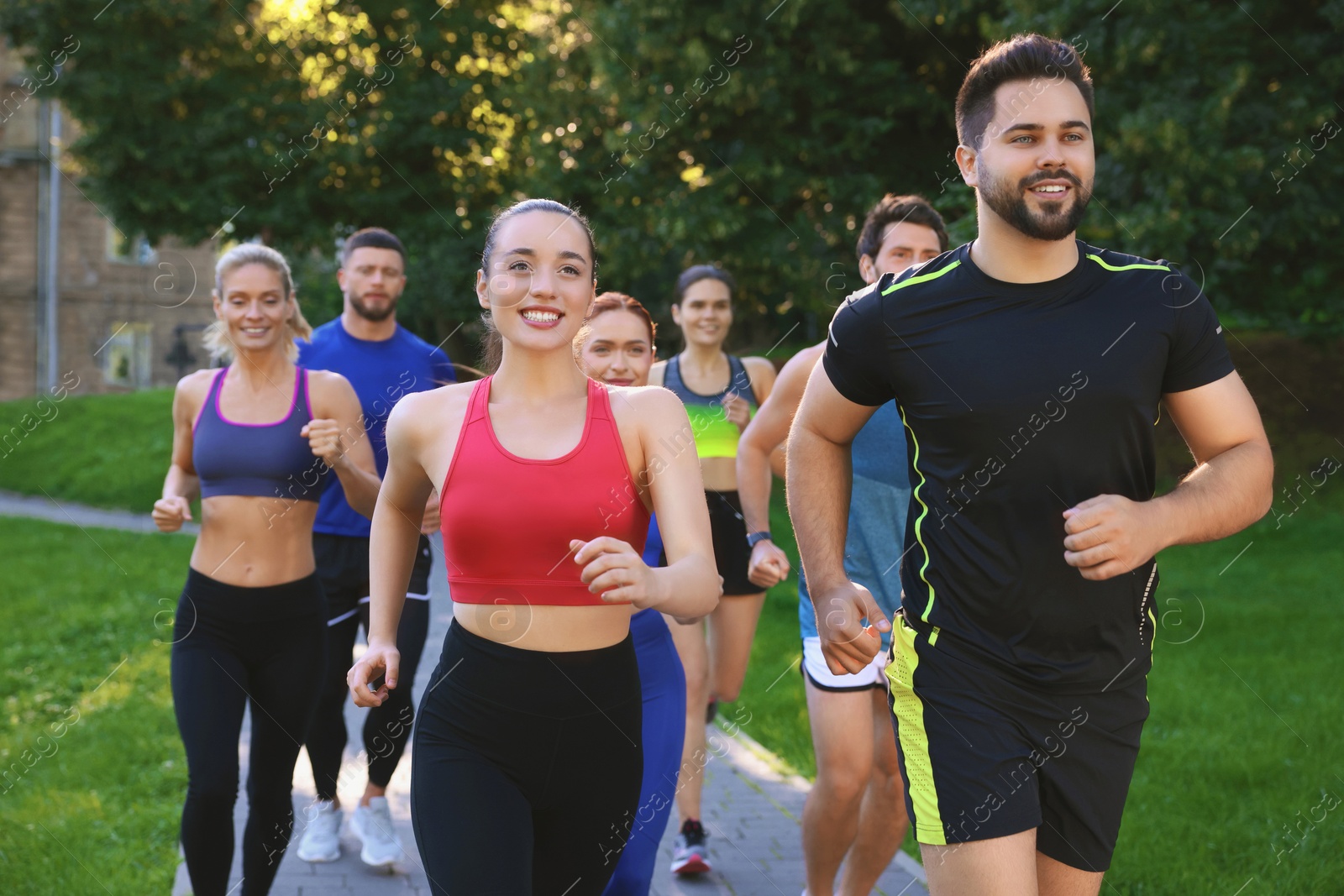 Photo of Group of people running in park. Active lifestyle