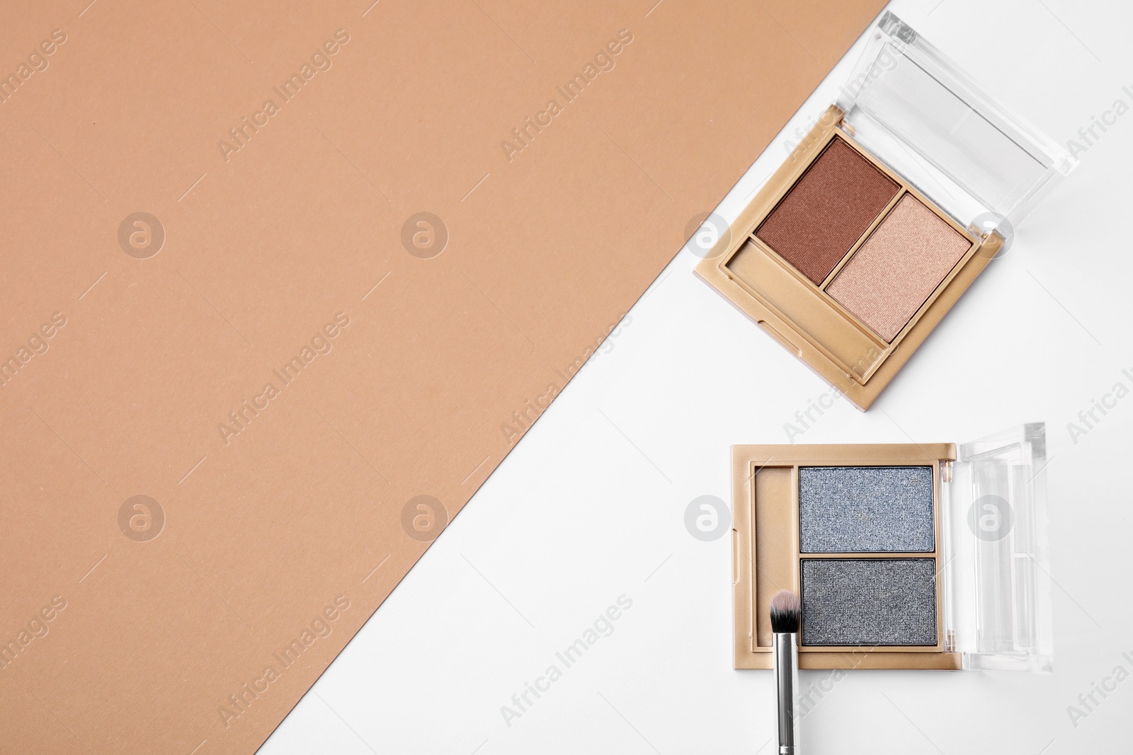 Photo of Eye shadow palettes and professional makeup brush on colorful background, flat lay. Space for text