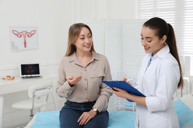 Photo of Young woman having appointment with gynecologist in clinic