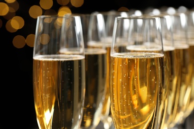 Photo of Many glasses of champagne on blurred background, closeup