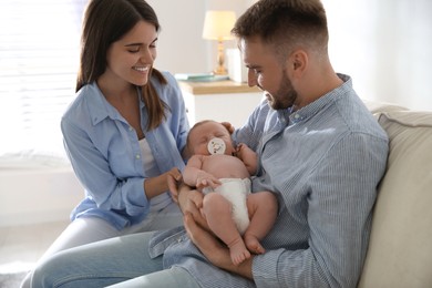 Happy couple with their newborn baby at home