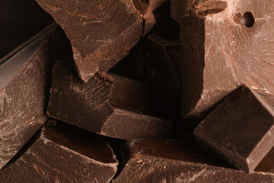 Photo of Pieces of dark chocolate as background, closeup