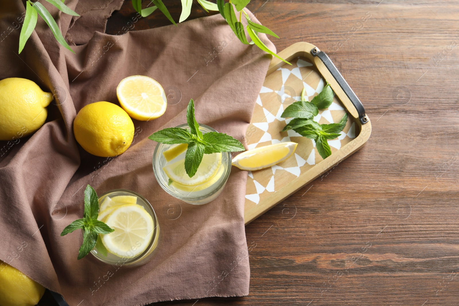 Photo of Flat lay composition with natural lemonade on wooden background