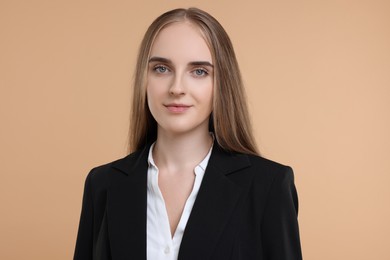 Portrait of young secretary on beige background